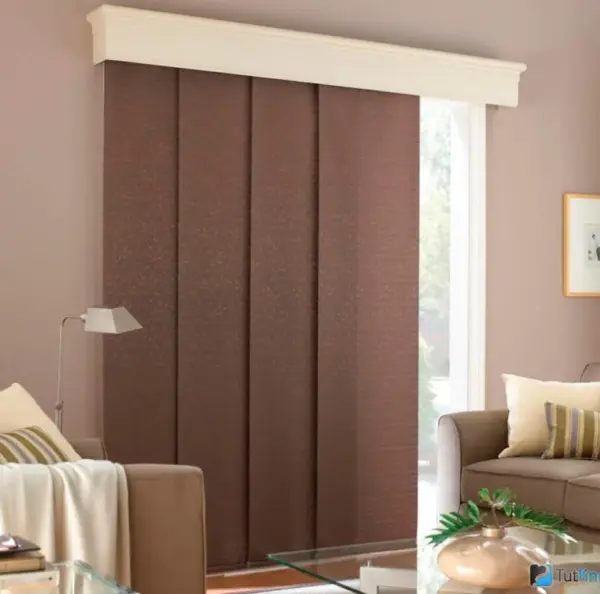 A cozy living room with brown panel blinds and a comfortable couch.